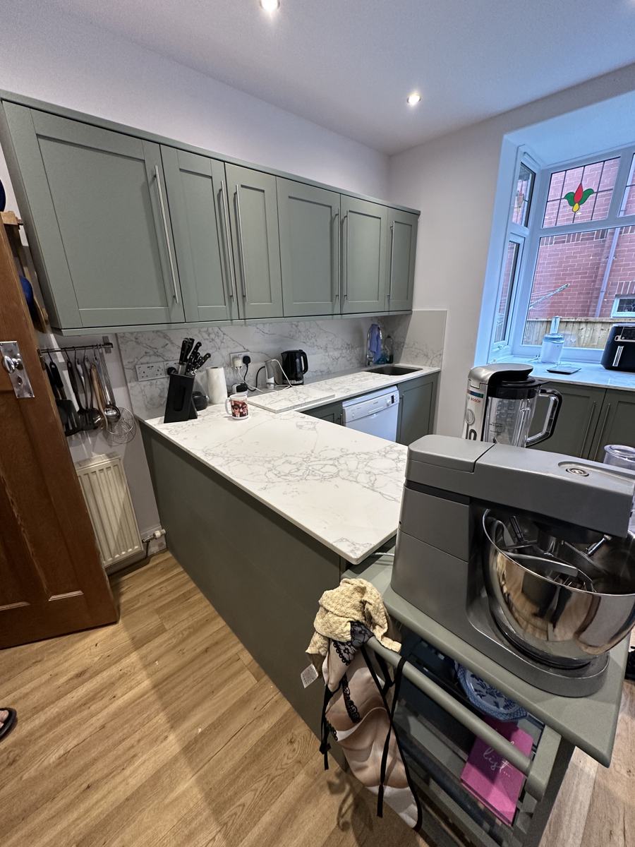 Mossley kitchen after: green shaker units and white quartz worktops