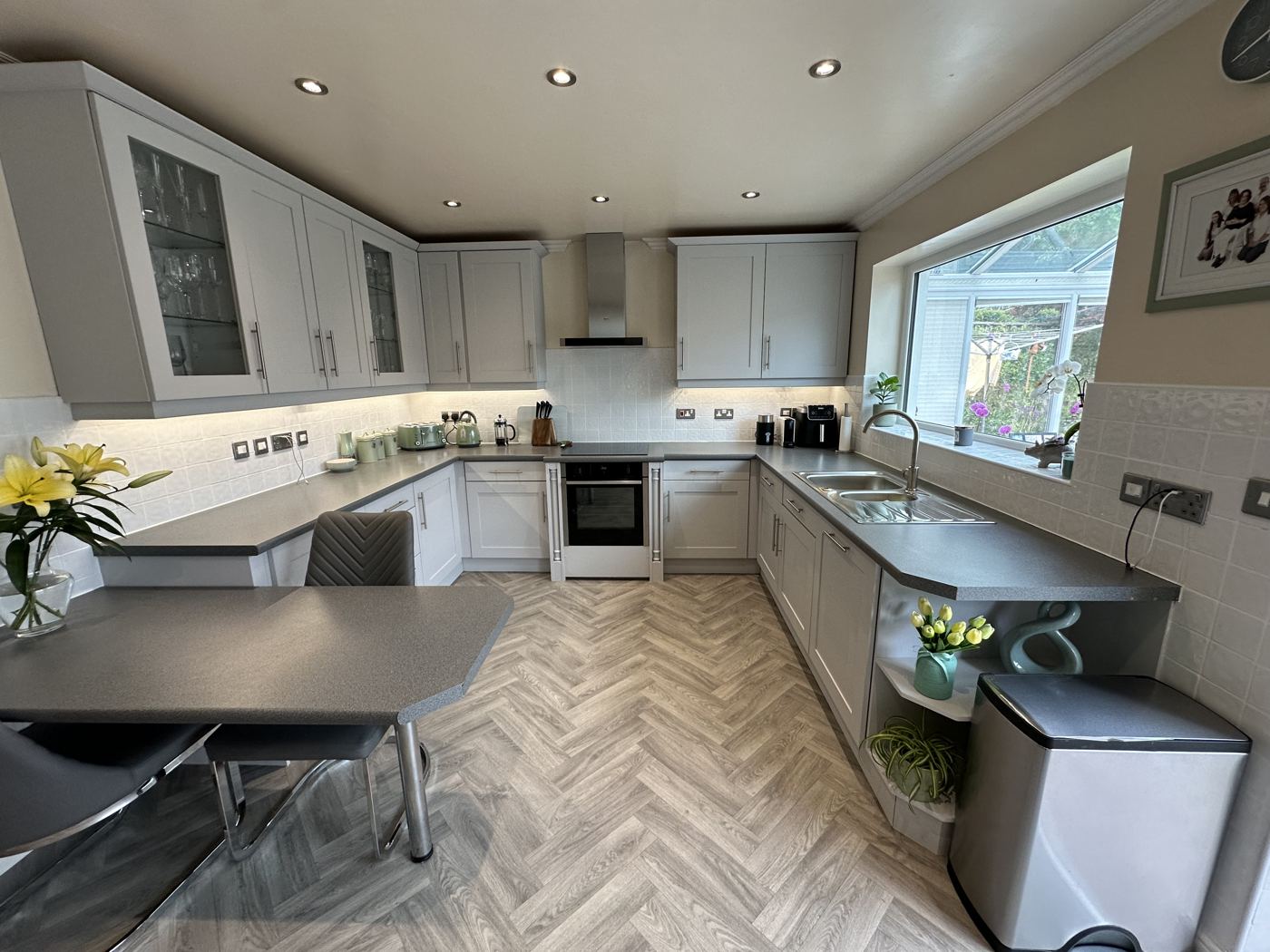 Greenfield kitchen after: light grey units and herringbone floor