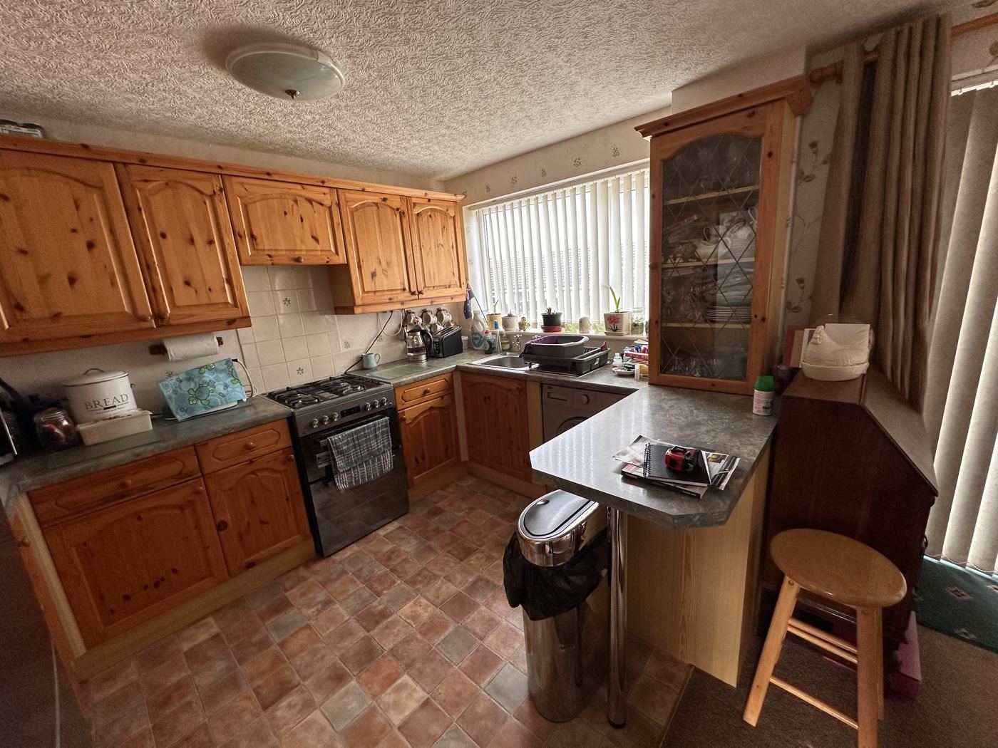 Stalybridge kitchen before: pine units and patterned vinyl floor