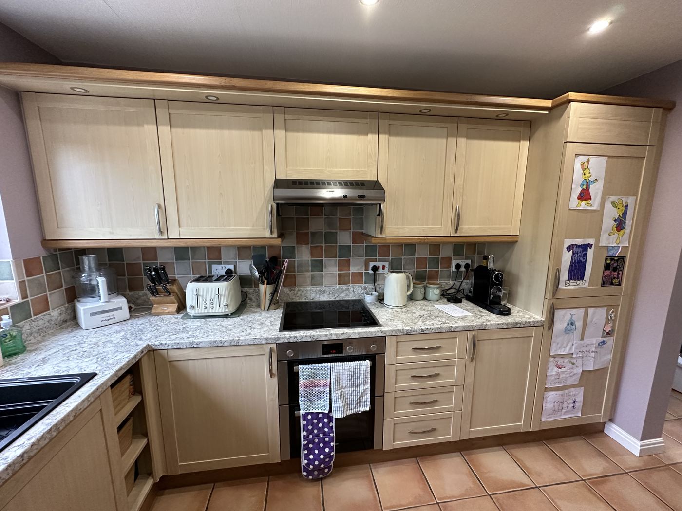 Mossley kitchen before: beech-effect units and terracotta tiled floor