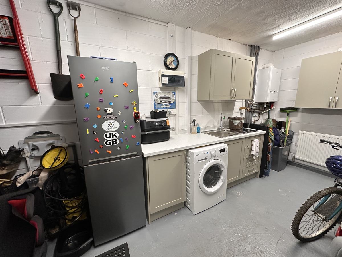 Garage after: new utility area with sink, units and washing machine